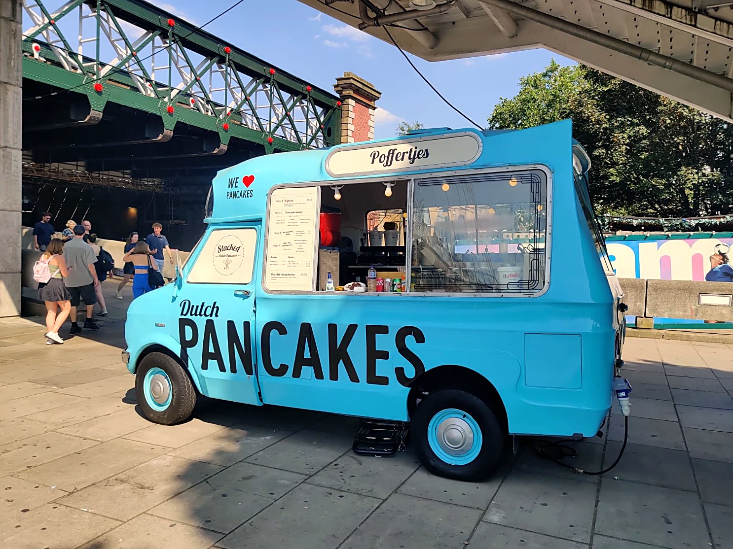 Stacked's vintage blue Dutch pancake van serving fresh poffertjes on Queen's Walk at the Southbank Centre, London
